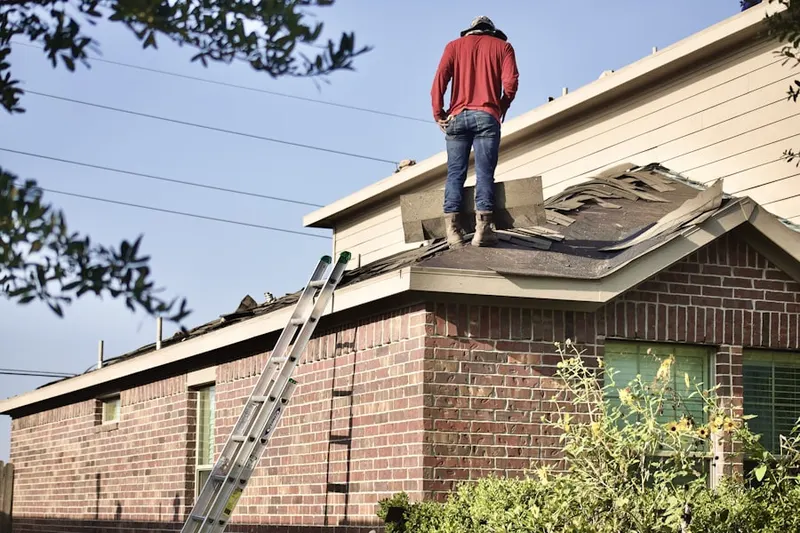 Professional roofer working on a residential roof in Tocsin